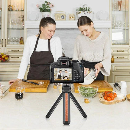 PULUZ Inlaid Wood Tripod for Desktop Vlogging and Live Streaming set up on kitchen counter with camera filming two women cooking, compact stable desktop support