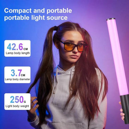 PULUZ Handheld RGB LED Light for Photography and Video Use shown with model holding compact portable RGB tube light against purple background