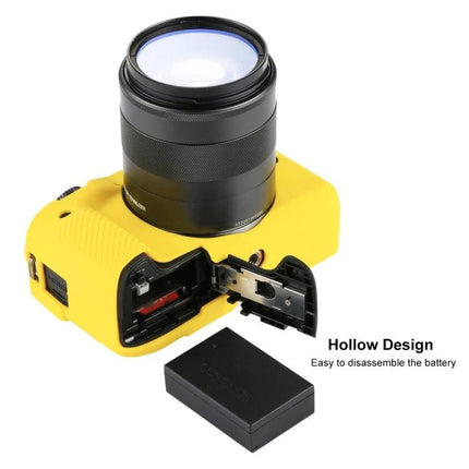 PULUZ Soft Silicone Protective Case for Canon EOS M3 yellow case showing battery compartment and lens attached
