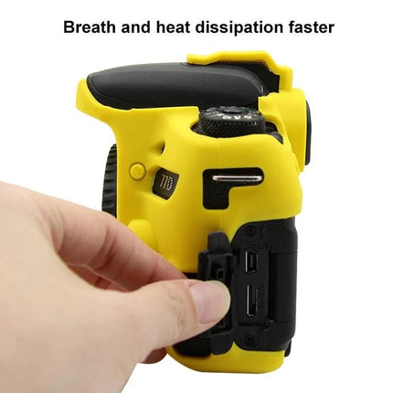 PULUZ Soft Silicone Protective Case for Canon EOS 77D Camera showing yellow silicone cover with hand accessing camera ports