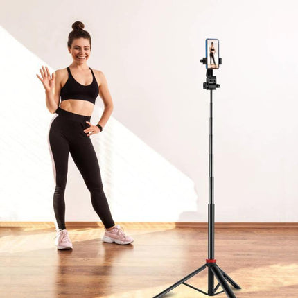 PULUZ Telescopic Tripod for Home and Travel Lighting Sessions showing a woman recording a fitness selfie with adjustable height and phone mount