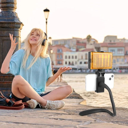 PULUZ Silicone Flexible Mount Holder for Phones and GoPro mounted on phone with LED light used for hands-free vlogging by waterfront