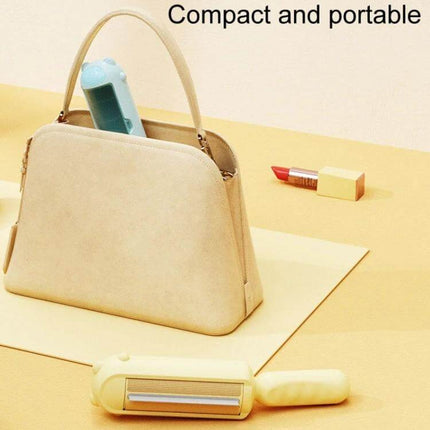 Pet Hair Remover Brush Electrostatic For Clothes And Bedding compact portable brush beside handbag and lipstick