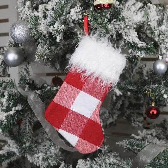 Plush Christmas Sock Gift Bag Ornament For Holiday Decor Red And White - red plaid plush stocking with white faux fur cuff hanging on snowy Christmas tree