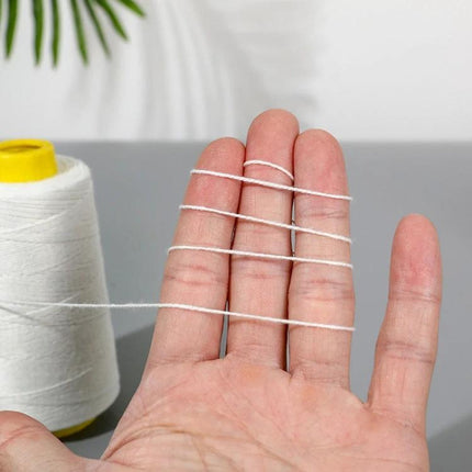 Polyester Rice Bag Sealing Thread For Sewing, 125g spool of white 3-strand polyester thread shown wrapped across hand for rice bag repairs