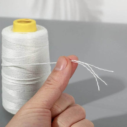 Polyester Rice Bag Sealing Thread For Sewing, 125g spool showing 3-strand cross-wound white thread held between fingers