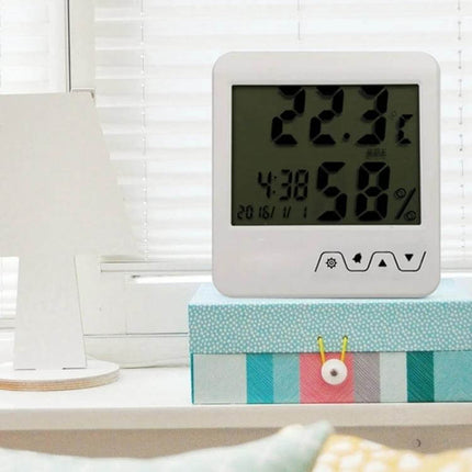 Portable Indoor Thermometer Hygrometer For Home Use digital display showing 22.3°C and 58% humidity on a white compact unit on a windowsill
