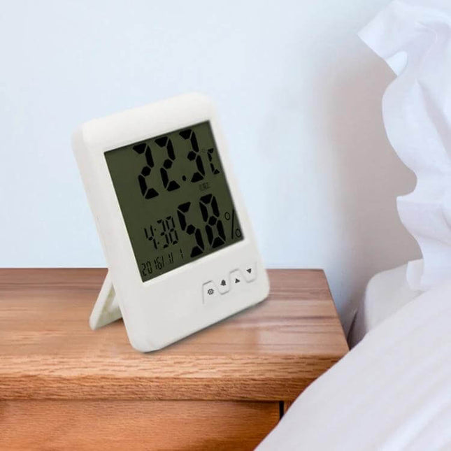 Portable Indoor Thermometer Hygrometer For Home Use on bedside table showing temperature and humidity readings
