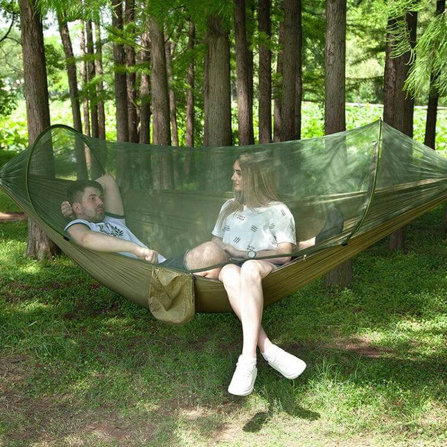 Portable Outdoor Camping Nylon Parachute Hammock 250x120cm with integrated mosquito net showing two people relaxing in a forest setup