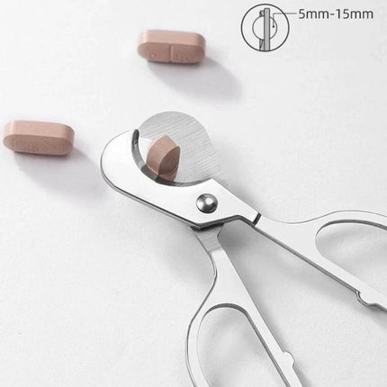 Portable Pill Cutter With Stainless Steel Blades, Oval Handle cutting a tablet with corrosion‑resistant stainless steel blades and ergonomic oval handle