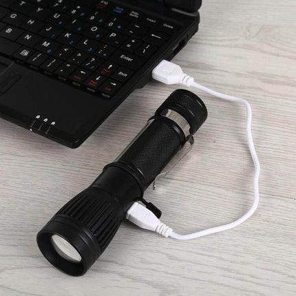 Portable USB Charging LED Flashlight One Click Operation showing black flashlight charging from laptop USB, compact emergency light and power bank