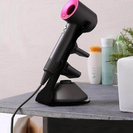Punch Free Standing Hair Dryer Stand For Dyson Silver on gray salon table holding a Dyson-style hair dryer, mild steel polished base
