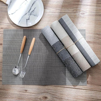 PVC Non Slip Table Mat 30x45cm Easy Clean Placemat on wooden table with utensils and rolled mats, non-slip heat-resistant wipe-clean placemat