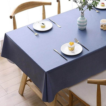 PVC Oil-Proof Waterproof Disposable Tablecloth 140x220 cm on dining table with blue imitation hemp texture, wipe-clean surface and non-slip underside