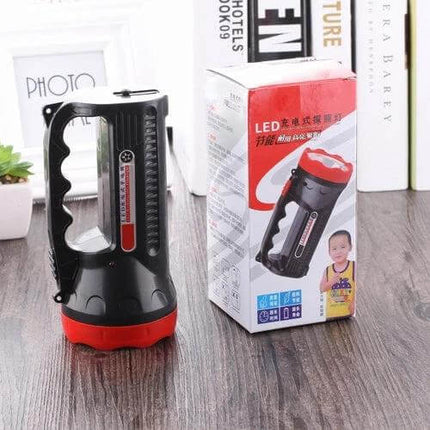 Rechargeable Outdoor LED Flashlight With Two Modes shown next to its retail box on a wooden surface