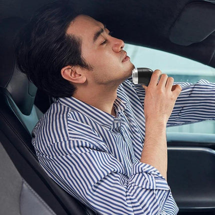 Rechargeable Travel Electric Shaver With Floating Head in hand of man shaving neck while seated in car, Type-C charging, compact travel grooming tool
