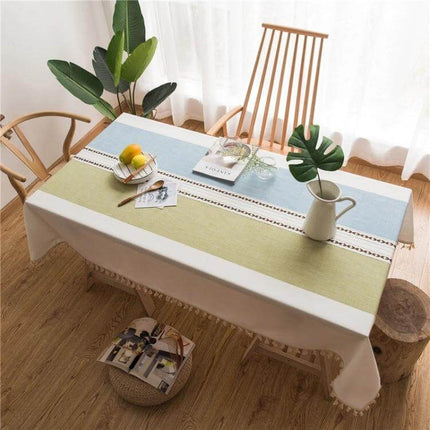 Rectangle Cotton Linen Tassels Dining Tablecloth 140x300cm on wood table with green and blue stripes, tassel edges, pitcher and fruit styling