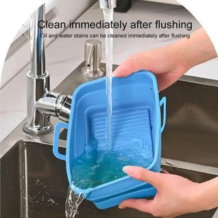 Rectangular Foldable Silicone Air Fryer Basket being rinsed under a kitchen faucet to show easy cleaning and foldable silicone liner