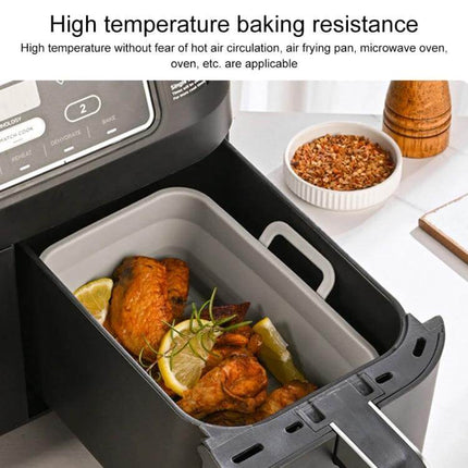 Rectangular Foldable Silicone Air Fryer Basket in air fryer with roasted chicken, lemon and herbs to prevent sticking and simplify cleanup