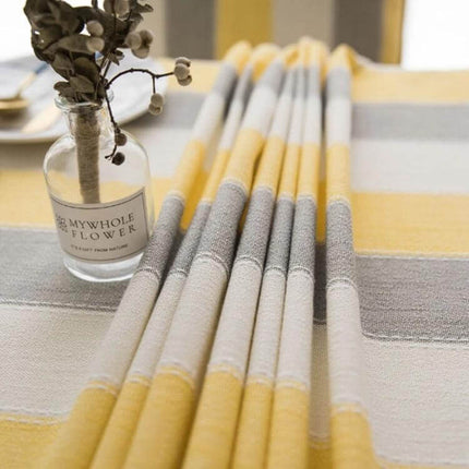 Rectangular Striped Tablecloth Cover For Dining Tables in neutral yellow gray stripes on a waterproof polyester fabric protecting a dining table