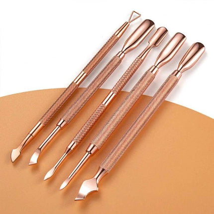 Rose Gold Stainless Steel Double-Headed Dead Skin Scissors For Nails pictured with textured rose-gold cuticle pushers for precise manicure care