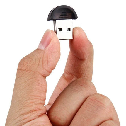 Bluetooth USB Dongle for Wireless PC Device Connections - compact USB adapter held between fingers for adding Bluetooth to older PCs