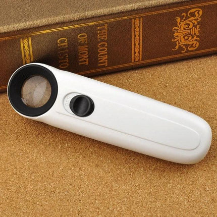 Handheld 40X Magnifier with LED Light for Everyday Reading — white handheld loupe with integrated LED beside book, ideal for reading fine print