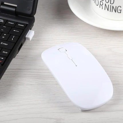 White wireless optical mouse on desk beside laptop and mug - Wireless Optical Mouse for Everyday Computing Use, 2.4GHz responsive tracking