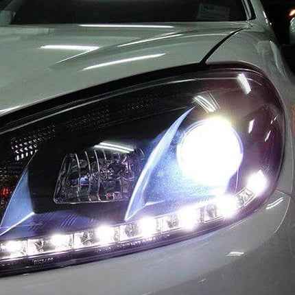 H7 Halogen Car Headlight Twin Pack For Night Driving close-up of bright white halogen headlight on car with blue silver black casing