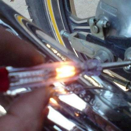 Tool for Checking Car Electrical Systems in Daily Maintenance - handheld tester checking motorcycle wiring and bulb illumination