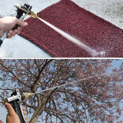Durable Copper High-Pressure Water Gun for Car and Outdoor Cleaning spraying a doormat and tree to remove dirt and debris