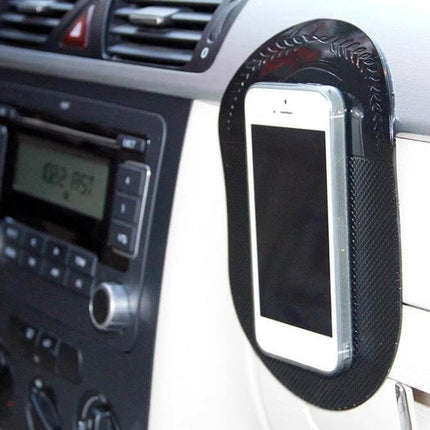Car Anti-Slip Sticky Mat for Phones and Car Accessories securing a smartphone on a car dashboard during driving, durable rubber non-slip pad