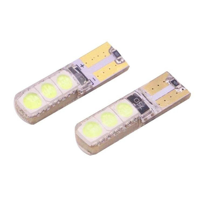 Ice Blue Vehicle LED Bulbs for Turn Signals and Brake Lights - close-up of two small T10/W5W style ice blue LED replacement bulbs for car signals and brake lights