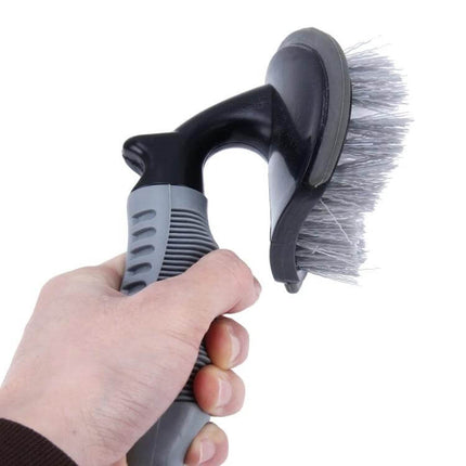 KANEED Car Wheel Brush for Cleaning Tires and Surfaces held in hand showing bristles and ergonomic grip for scrubbing wheels and rims