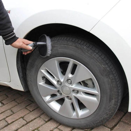 KANEED Car Wheel Brush for Cleaning Tires and Surfaces being used to scrub a car tire and rim with soap and water