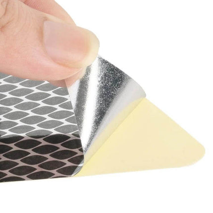 Pair of Car Decoration Stickers for Easy Vehicle Styling - close-up of hand peeling square reflective sticker ready for door or bumper application
