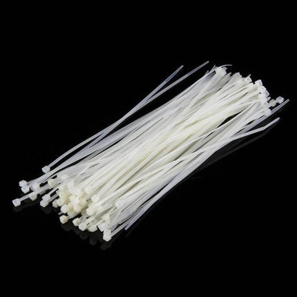 Self-Locking Nylon Cable Ties, 3mm x 150mm, Black and White Pack of 500 - bundle of white 3mm x150mm self-locking nylon cable ties on black background
