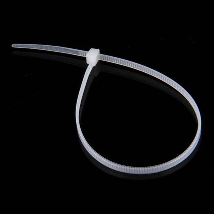 Self-Locking Nylon Cable Ties, 3mm x 150mm, Black and White Pack of 500 - single white tie on black background for cable management