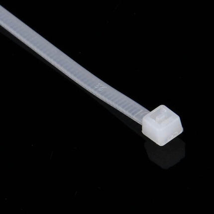 Self-Locking Nylon Cable Ties, 3mm x 150mm, Black and White Pack of 500 - close-up of white 3mm x 150mm nylon cable tie on black background