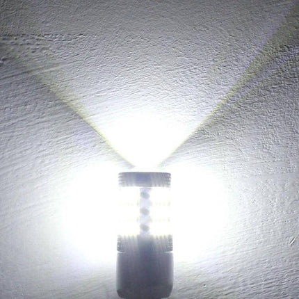 White LED Car Bulb For Parking Lights And Turn Signals - bright plug-and-play replacement shown illuminated against wall