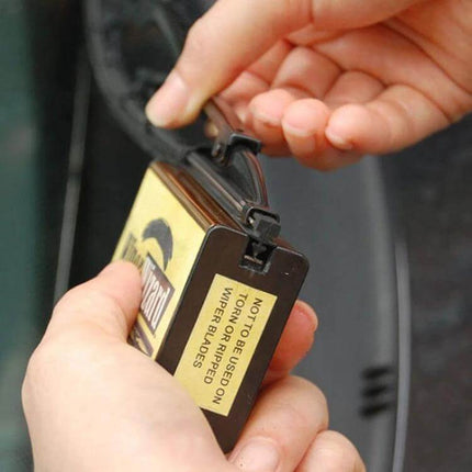 Wiper Wizard Windshield Wiper Blade Restorer for Clear Visibility being used to lift grime from a wiper blade for clearer wipes