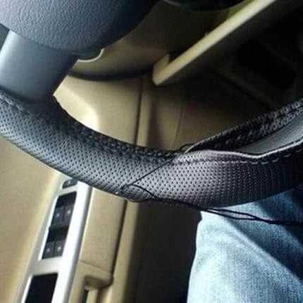 PU Leather Steering Wheel Cover With Needle And Thread 54x10.5cm installed on 38cm wheel showing black perforated PU leather and included needle for DIY fit
