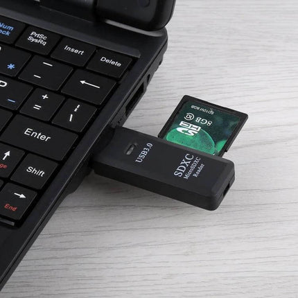 Dual Slot USB 3.0 Card Reader for SD and Micro SD Cards plugged into laptop USB port with SD card inserted