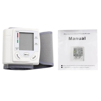 Automatic Wrist Blood Pressure Monitor For Home Use white wrist cuff and manual on white background