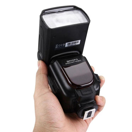 Triopo Flash Speedlite for Canon and Nikon DSLR Cameras handheld black external flash unit showing head and hotshoe
