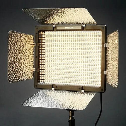 Yongnuo LED Video Light for Canon, Nikon, and Sony DSLR Cameras on stand with adjustable barn doors and warm LED panel for studio and location shoots