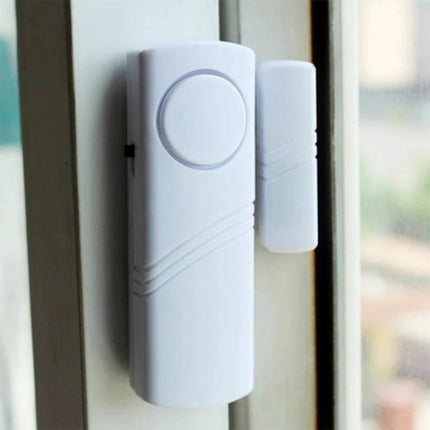 Wireless Magnetic Alarm for Doors and Windows Security mounted on a white window frame, peel-and-stick entry sensor alerting when magnet separates