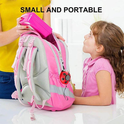 Ladybug Personal Alarm for Everyday Safety of Kids and Women - small portable red ladybug alarm attached to a pink school backpack