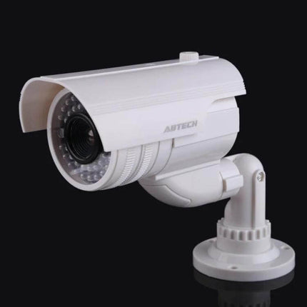 Realistic Dummy Security Camera with Flashing Red LED Light mounted on wall showing white housing and lens to deter intruders