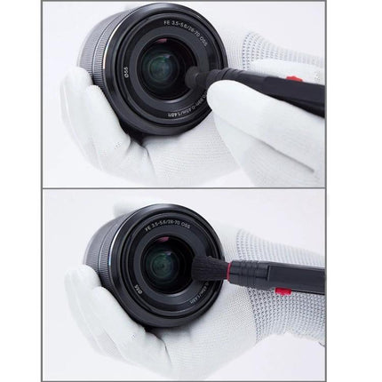 Two in One Lens Cleaning Pen for Cameras and Digital Lenses gently cleaning camera lens with brush and tip held by gloved hands